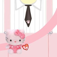 a hello kitty stuffed animal with a pink ribbon around it's neck and tie on the wall