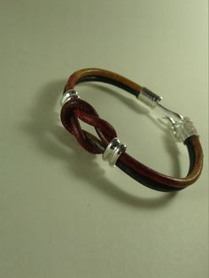 Casual style leather and silver bracelet. Genuine leather in multi-color 3mm cord with sterling silver sliders and end caps.  This is strictly casual and fun. Made of good quality leather (no faux stuff) and sterling silver. Very comfortable and easy to fasten with an extender that gives you another inch if needed. You don't have to be a guy to wear leather. This little bracelet would be a great gift. Approx. 7  inch with 1 inch extender. Love Knot Bracelet, Leather Bracelets Women, Erie Pa, Bracelet Love, Bracelet Leather, Knot Bracelet, Love Knot, Braided Bracelets, Sliders