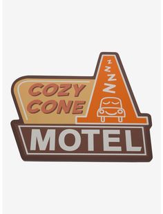 a sign that says cozy cone motel on the side of a white wall with an orange triangle