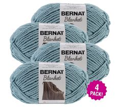 three balls of bernat blanket yarn in light blue, each with a different color