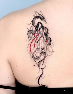 the back of a woman's shoulder with an artistic tattoo design on her upper arm