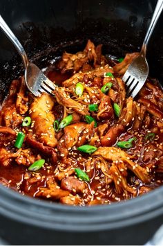 a slow cooker filled with chicken and sesame seeds