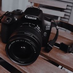 a camera sitting on top of a wooden bench