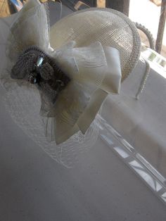 This Ivory Ribbon Lace Crystal Bow Sinamay Fascinator Hat with Veil and Pearl Headband is a beautiful accessory for weddings, bridesmaid, parties, and other special occasions. It is elegant, stylish, romantic, and super chic! Will definitely add a sparkling touch to your outfit!! I only accept PayPal and ship all orders within 24 hours via USPS. Feel free to send me a convo with any questions. Thank you for visiting Hettie Hair Accessories! White Bow Fascinator For Wedding, Elegant Bridal Accessories With Satin Bow, Elegant Hats For Vintage Events, Beige Mini Hat Headband For Weddings, Elegant Wedding Hats With Ribbon, Elegant Hat-style Fascinator For Vintage Events, Elegant Adjustable Hair Accessories For Ceremony, Adjustable Beige Headpieces For Wedding, Elegant Wedding Hair Accessories With Ribbon