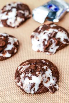 chocolate cookies with white icing and sprinkles