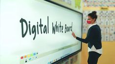 a woman wearing a face mask writing on a whiteboard with the words digital white board