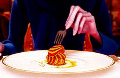 a woman sitting at a table in front of a plate with a piece of cake on it