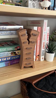 a book shelf with books and a bag on it