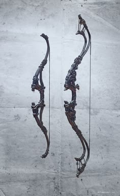 an artistic metal sculpture is displayed on the concrete wall, with two arrows pointing towards each other