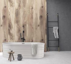 a white bath tub sitting next to a wooden wall