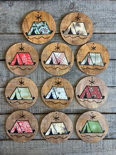 wooden coasters decorated with camping themed campers and tents on wood planked background