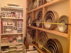 the shelves are filled with many different types of plates and pans on it's sides