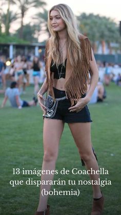 a woman standing on top of a lush green field next to a park filled with people