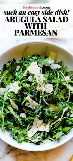 a white bowl filled with greens and cheese