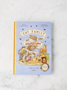 cat family at the museum book sitting on a marble surface