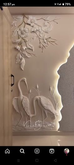 the wall is decorated with white flowers and two swans