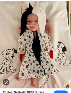 the baby is wearing a dalmatian costume