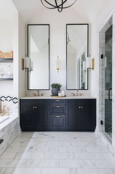 a large bathroom with two sinks and mirrors on the wall, along with marble flooring