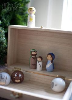 a wooden box filled with figurines on top of a table