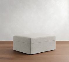 a white box sitting on top of a wooden floor