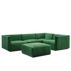 a green couch and ottoman sitting next to each other