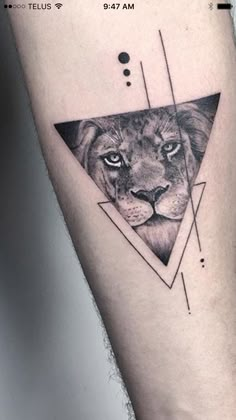 a black and white photo of a lion in a triangle tattoo on the left leg