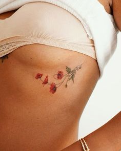 a close up of a woman's stomach with flowers on it