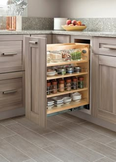 an open cabinet in the middle of a kitchen