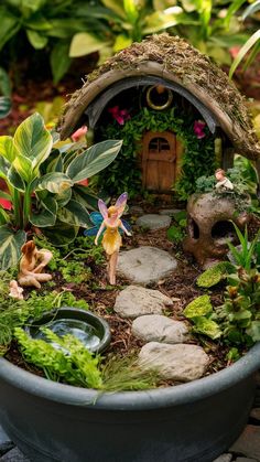 a fairy garden is shown in a pot