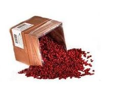 a wooden box filled with cranberry seeds