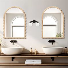 two sinks with mirrors above them in a bathroom