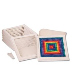 a set of four square coasters with different colored squares on the front and sides