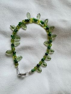 Designed to look like a vine, green beaded leaf bracelet. Silver clasp. Cheap Cute Green Bracelets, Affordable Green Hypoallergenic Friendship Bracelets, Cheap Traditional Green Beaded Bracelet, Cheap Green Beaded Bracelets For Birthday, Cheap Handmade Green Friendship Bracelets, Leaf Bead Bracelet, Handmade Bead Bracelets, Ivy Bracelet, Beaded Ideas