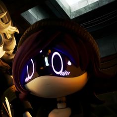 a close up of a cartoon character with glowing eyes and headgear, in a dark room