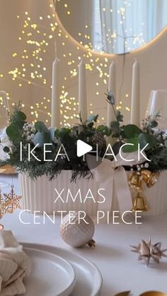 a white table topped with plates and candles