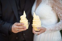 the bride and groom are holding ice cream cones