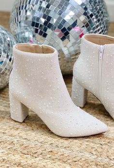 Step into luxury with the Christine Pearl Bootie. These beautiful white pearl booties are perfect for any special occasion. Featuring a stacked heel, they add a touch of elegance to any outfit. Whether you're a bride to be or heading out for a night on the town, these booties are sure to turn heads. 3" stacked heel Runs small - We recommend sizing up a half size Side zipper Wedding Shoes For Fall Brides, White Boots Bride, Winter Bride Boots, Wedding Shoes Bride Winter, Wedding Shoes Bride Boot, Bridal Clothes, White Bridal Boots, White Booties Wedding Dress, White Boots Wedding