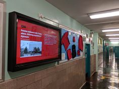 an empty hallway with posters on the wall