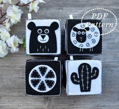 four black and white coasters with animals on them