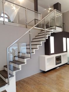 an empty living room with stairs leading up to the second floor