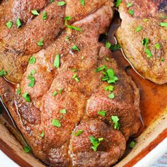 pork chops with parsley in a brown casserole dish