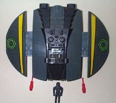 a star wars action figure hanging from the side of a wall next to a clock