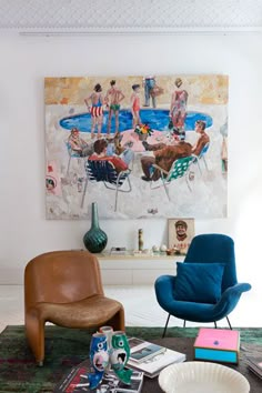 a living room filled with furniture and a painting on the wall