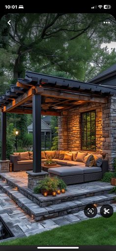 an outdoor living area with couches and lights