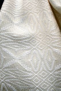 a white cloth with an intricate design on it