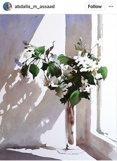 a vase filled with white flowers sitting on top of a window sill next to a wall