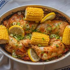 a pan filled with chicken and corn on the cob