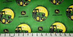 a green and yellow john deere fabric with tractors on it