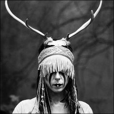 a woman with long hair and horns on her head