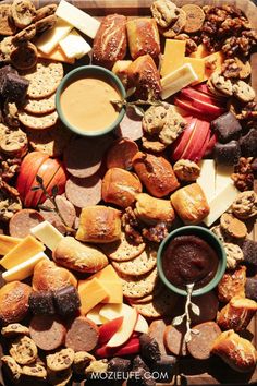 a tray filled with different types of food and dipping sauce on top of each other